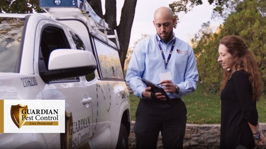 Employee pointing at his tablet with his customer