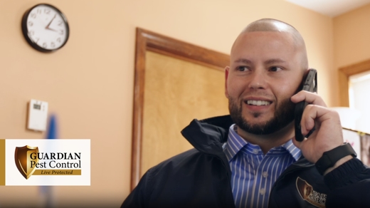 Man smiling while talking on the phone